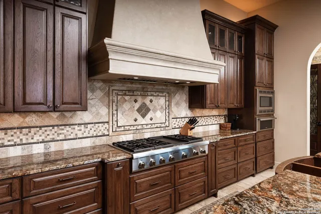 a living room with furniture a chandelier and a flat screen tv