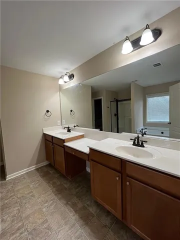 a spacious bathroom with a granite countertop sink mirror and a