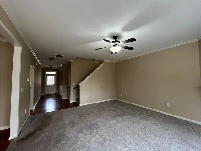 wooden floor in an empty room with a chandelier