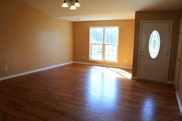 178 Thomas Road Livingston, TN 38570 - Photo 8 of 20 an empty room with wooden floor and windows
