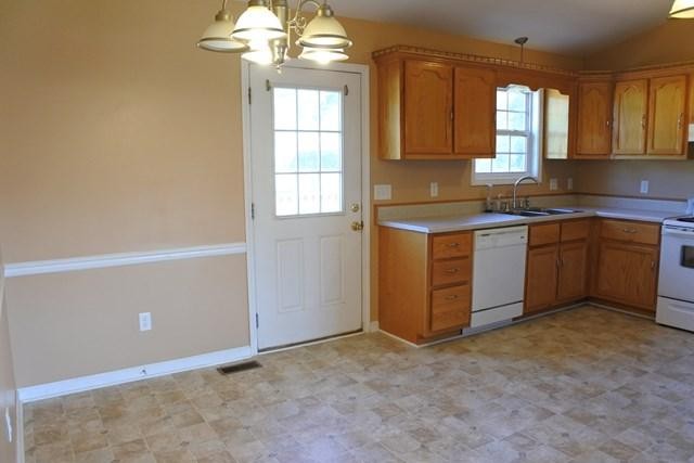 178 Thomas Road Livingston, TN 38570 - Photo 9 of 20 a kitchen with stainless steel appliances granite countertop a stove a sink and a refrigerator