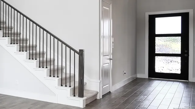 a view of entryway with stairs and wooden floor