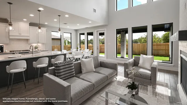 a living room with furniture and large windows