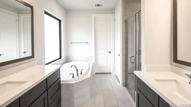 a spacious bathroom with a sink a mirror and a bathtub