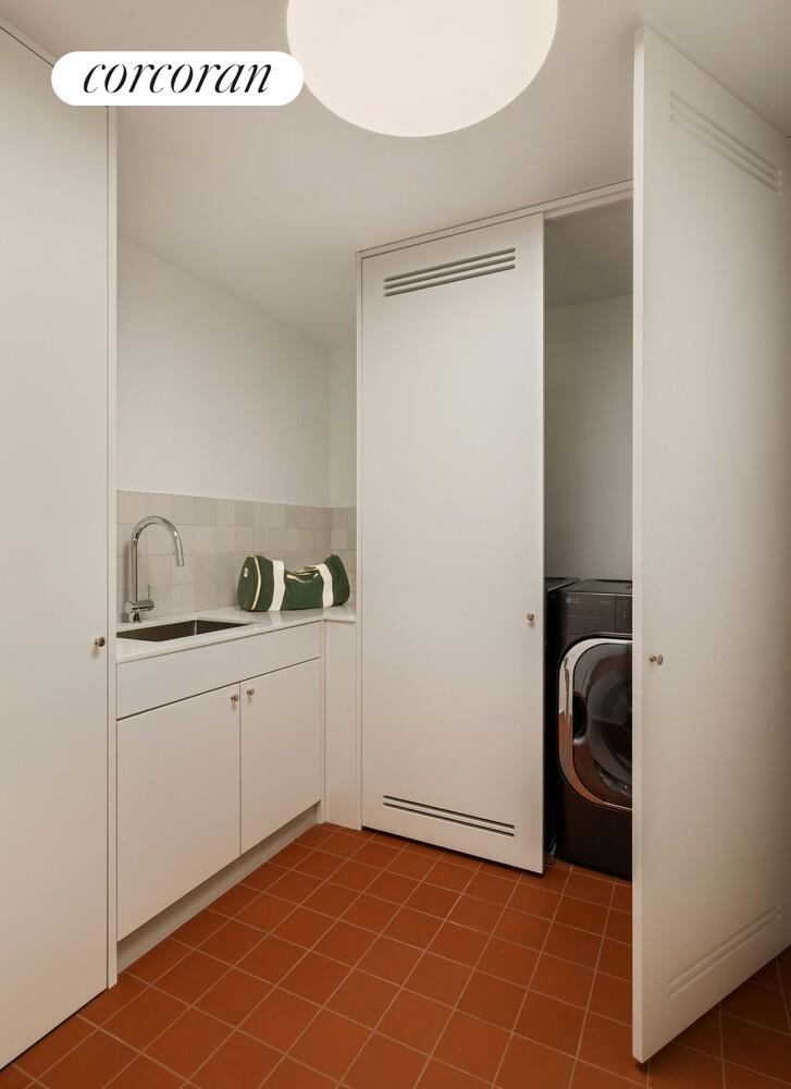 83 Thompson Street, Unit 4 Manhattan, NY 10012 - Photo 18 of 26 a utility room with a sink dryer and washer