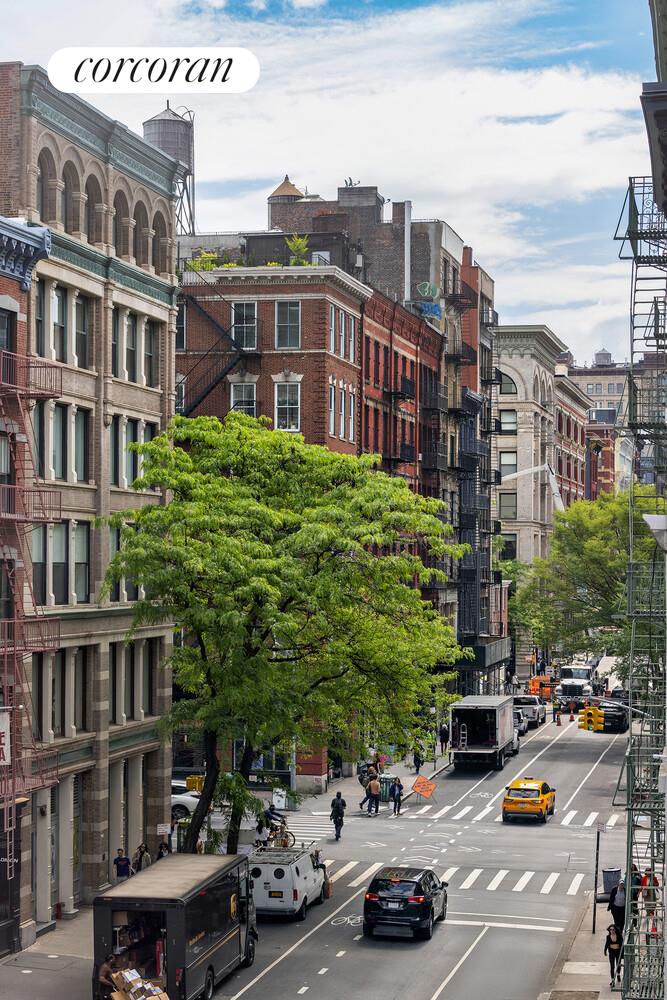 83 Thompson Street, Unit 4 Manhattan, NY 10012 - Photo 3 of 26 a city street lined with buildings and cars