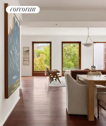 a kitchen with kitchen island granite countertop a refrigerator and a stove top oven