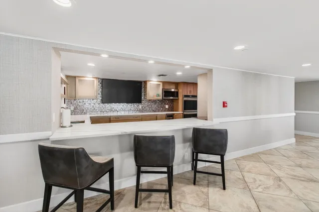 a living room with fireplace furniture and a large window