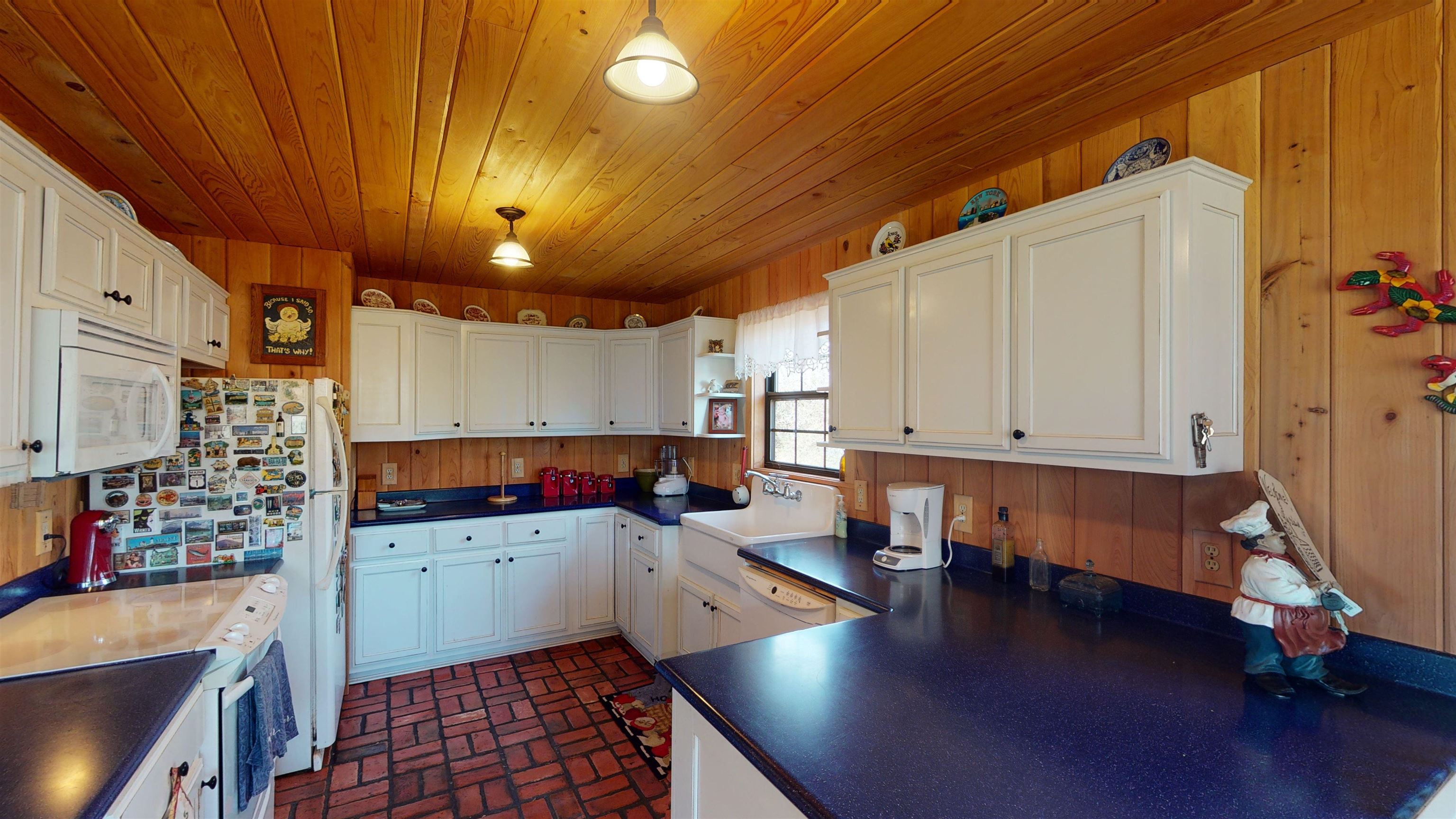 632 Mayflower Road Ramer, TN 38367 - Photo 7 of 25 a kitchen that has a lot of cabinets a sink and appliances