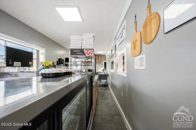 a kitchen with stainless steel appliances granite countertop a sink a stove top oven a chimney and a counter top space