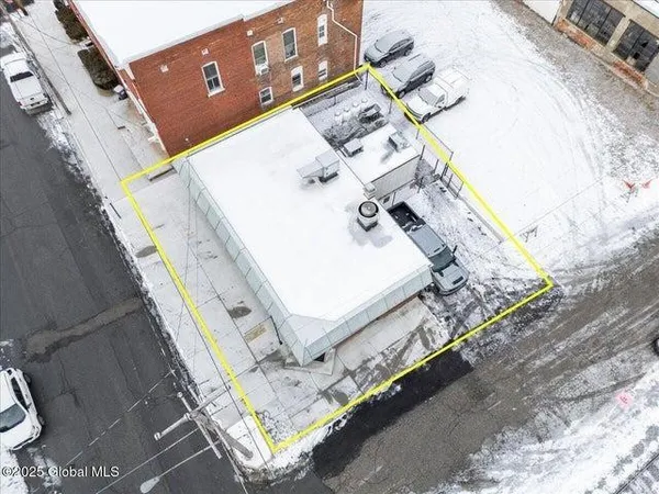 a aerial view of a house with a backyard