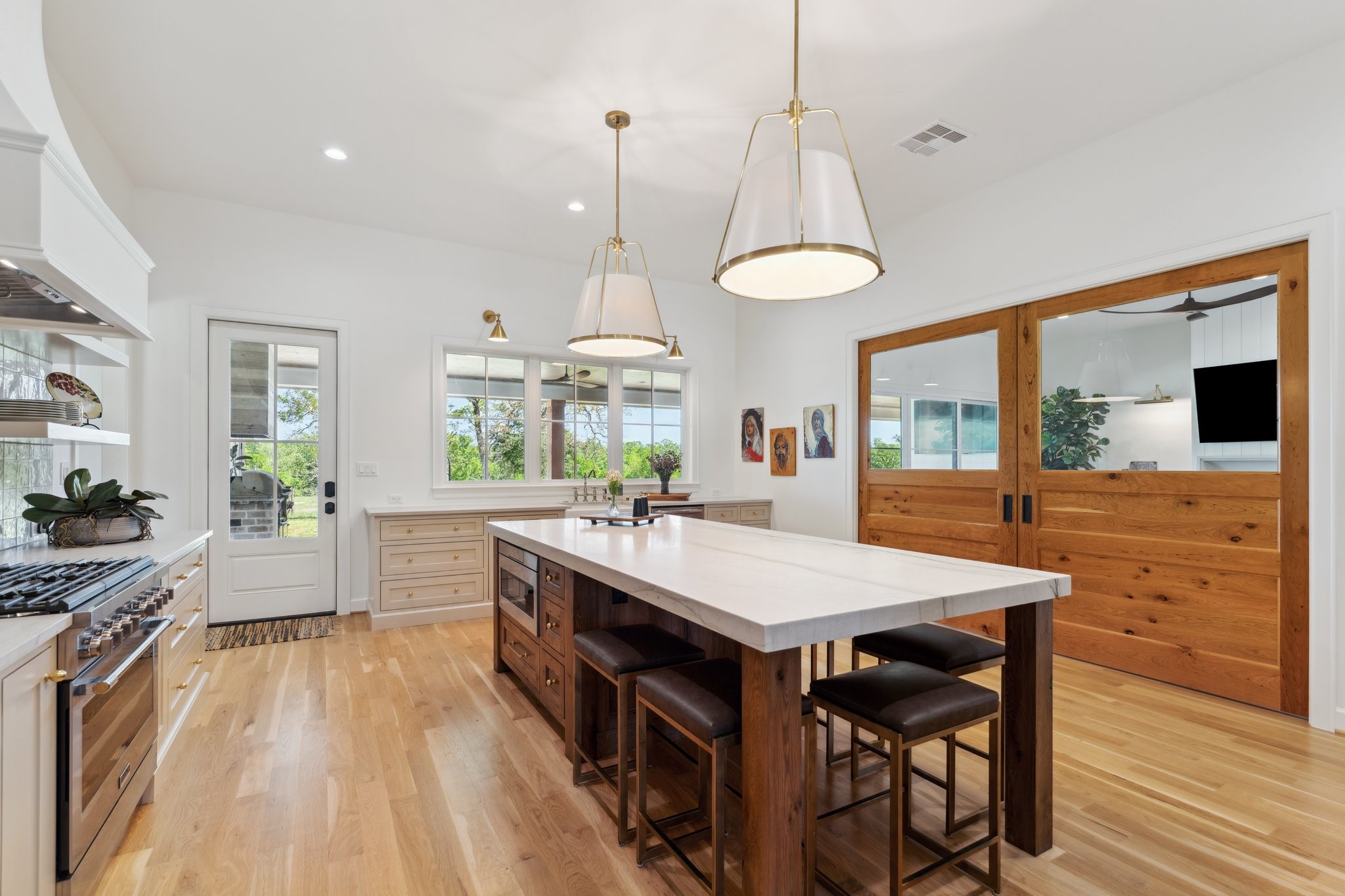 4052 Kuykendall Road Bellville, TX 77418 - Photo 8 of 40 Experience versatile living with elegant sliding pocket doors that effortlessly transform the open space by separating the kitchen from the family room, offering both connectivity and privacy as needed.