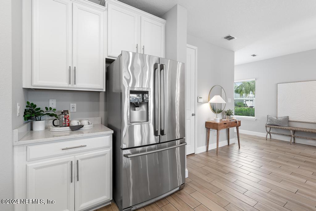 185 Clifton Bay Loop St. Johns, FL 32259 - Photo 15 of 92 a kitchen with white cabinets and stainless steel appliances
