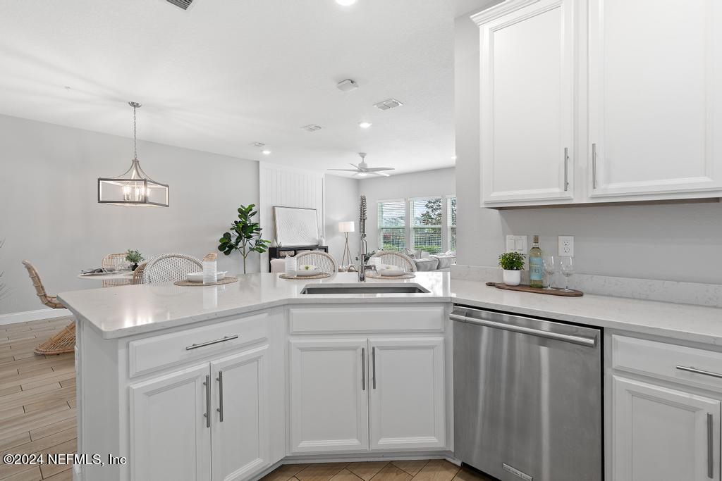 185 Clifton Bay Loop St. Johns, FL 32259 - Photo 17 of 92 a kitchen with white cabinets and sink