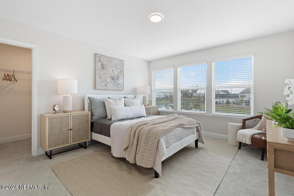 185 Clifton Bay Loop St. Johns, FL 32259 - Photo 30 of 92 a spacious bedroom with a bed and a couch