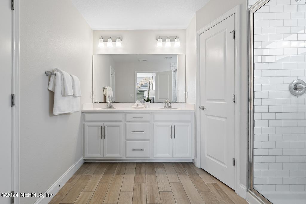 185 Clifton Bay Loop St. Johns, FL 32259 - Photo 34 of 92 a bathroom with a sink a mirror and a shower