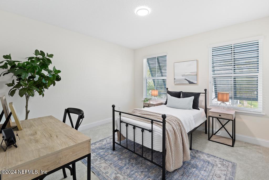 185 Clifton Bay Loop St. Johns, FL 32259 - Photo 39 of 92 a bedroom with bed and a potted plant