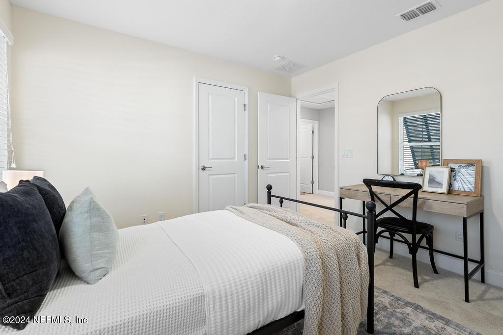 185 Clifton Bay Loop St. Johns, FL 32259 - Photo 40 of 92 a bedroom with a bed and a table