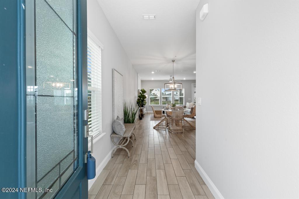 185 Clifton Bay Loop St. Johns, FL 32259 - Photo 6 of 92 a view of a hallway with furniture and wooden floor