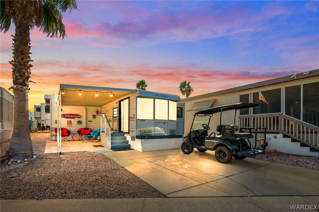 2000 Ramar Road, Unit 249 Bullhead City, AZ 86442 - Photo 2 of 40 Charming property with covered patio, private driveway, and inviting outdoor seating area, stunning Arizona sunsets included.