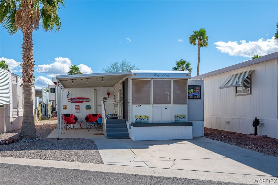 2000 Ramar Road, Unit 249 Bullhead City, AZ 86442 - Photo 3 of 40 Compact and functional layout with front entry steps, shaded patio, and low-maintenance desert landscaping.