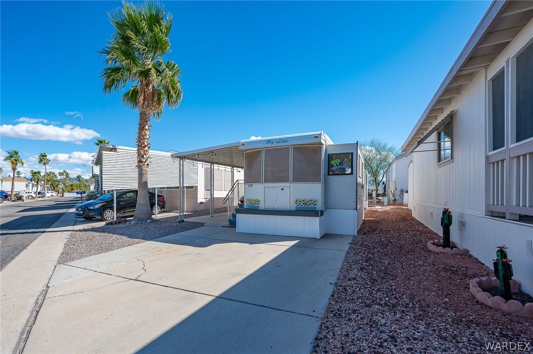 2000 Ramar Road, Unit 249 Bullhead City, AZ 86442 - Photo 4 of 40 Extended concrete driveway with covered parking and space for golf cart or additional storage.