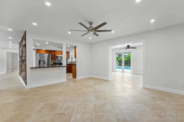a view of an empty room with a kitchen
