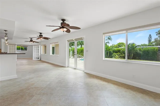a view of a livingroom with a ceiling fan and window