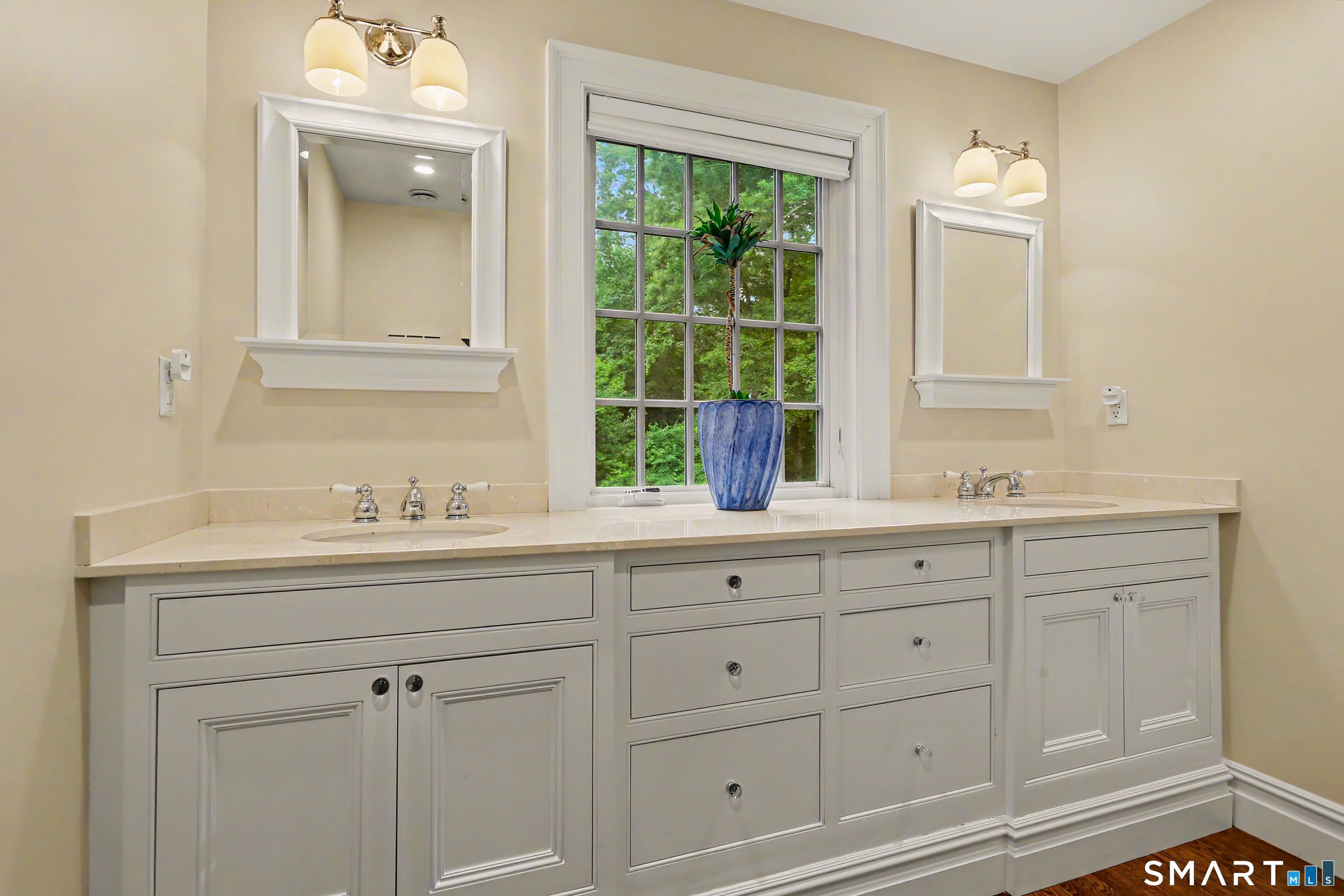 108 Logan Road New Canaan, CT 06840 - Photo 32 of 40 a bathroom with white cabinets a sink and dishwasher with wooden floor