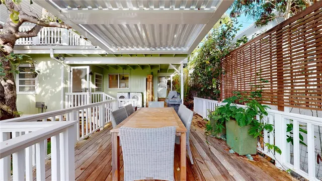 a view of a house with entrance stairs and a garden