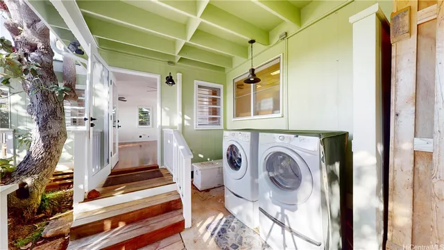 a view of a bedroom with washer and dryer