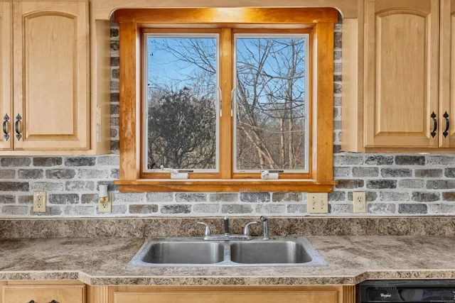 a kitchen with granite countertop a sink and a window