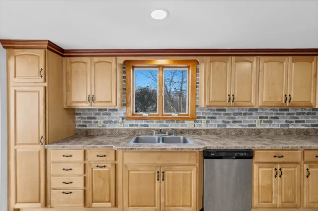 a kitchen with granite countertop a sink and a window