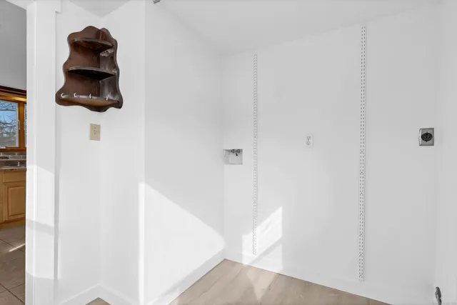 a view of small space with wooden floor and a window