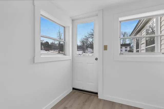 a view of a big room with wooden floor and windows in a room