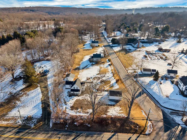 an aerial view of residential houses with city view