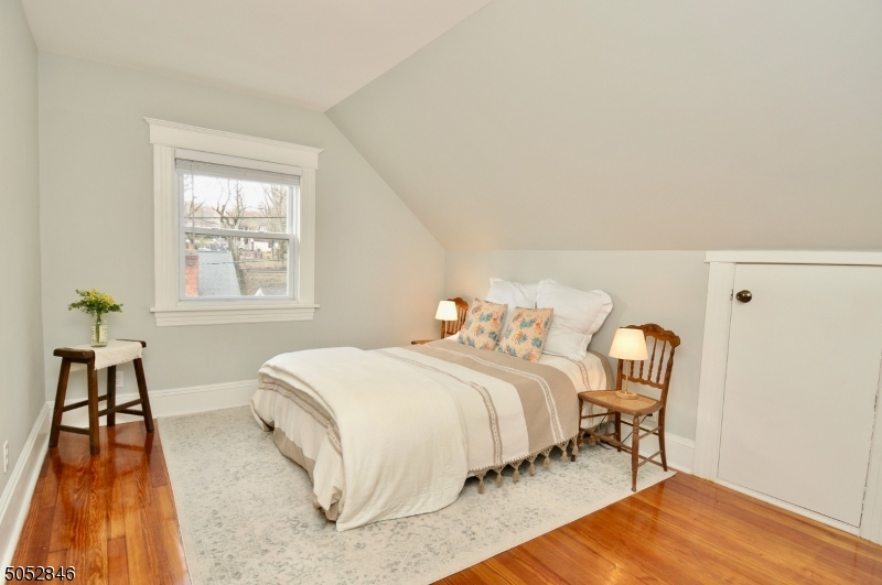 44 Dunnell Road Maplewood, NJ 07040 - Photo 14 of 18 a bedroom with a bed and a chair