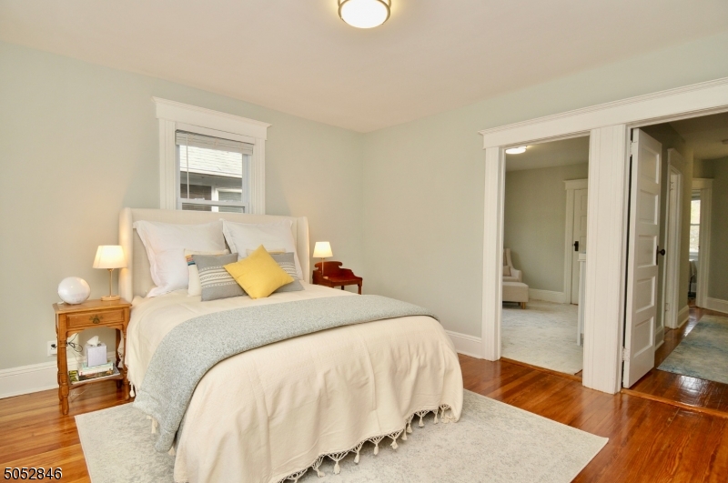 44 Dunnell Road Maplewood, NJ 07040 - Photo 9 of 18 a bedroom with a bed and a mirror