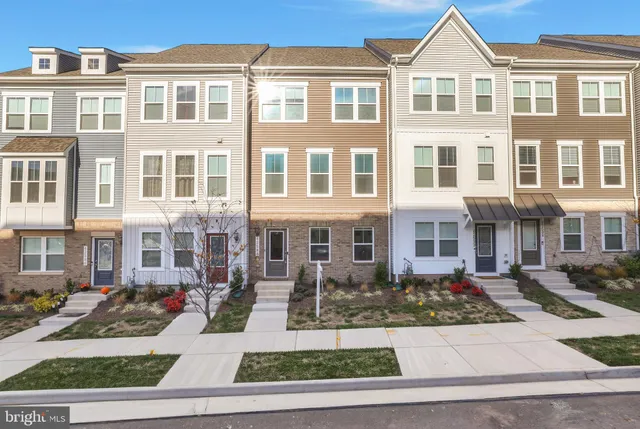 a front view of a residential apartment building with a yard