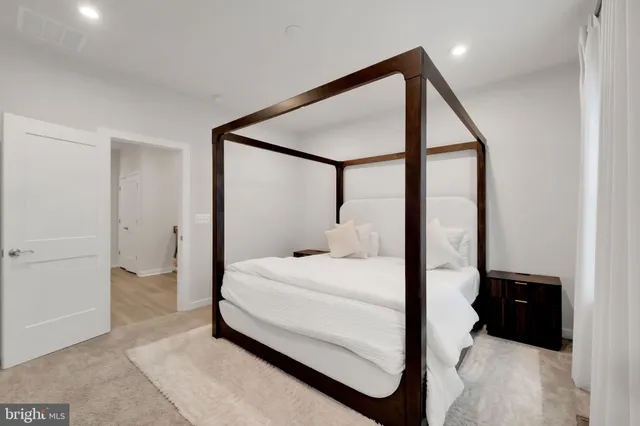 a bedroom with a bed and a mirror