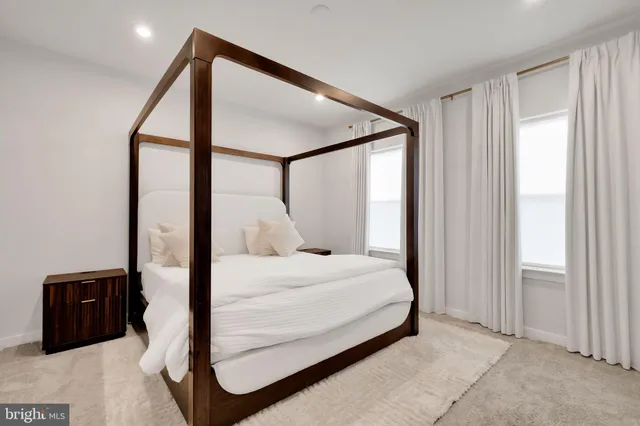 a bedroom with a bed and a large mirror