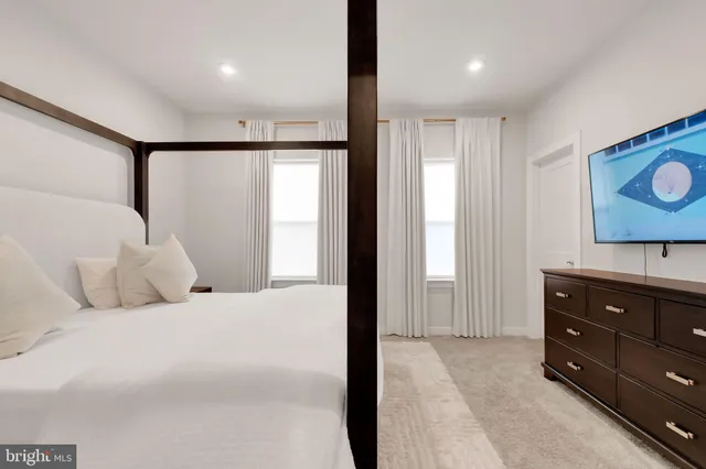 a bedroom with a bed and a dresser in it