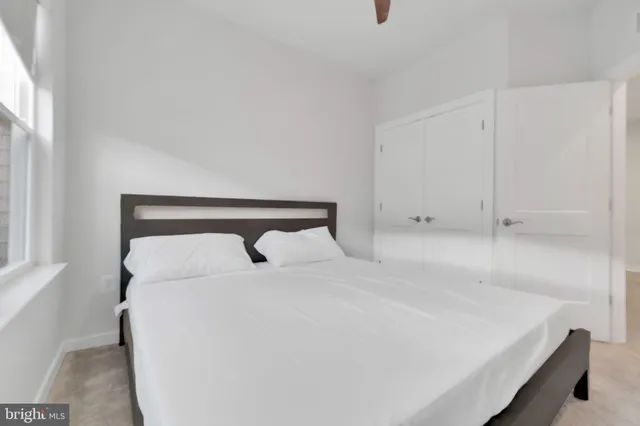 a bedroom with a bed and a window