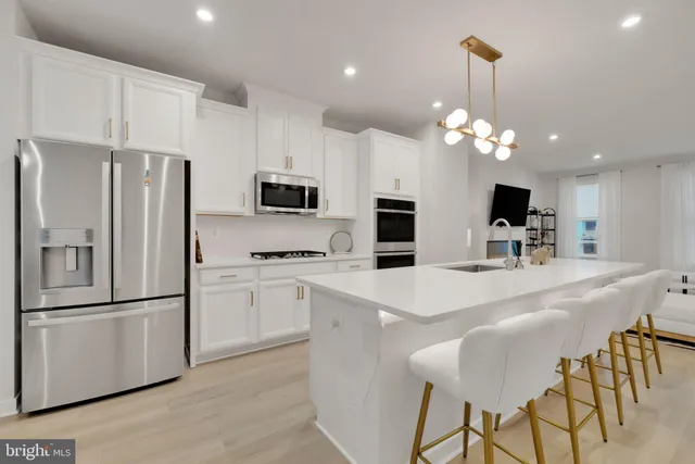 a kitchen with kitchen island appliances cabinets and furniture