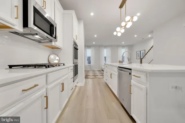 a kitchen with stainless steel appliances kitchen island granite countertop a sink and cabinets