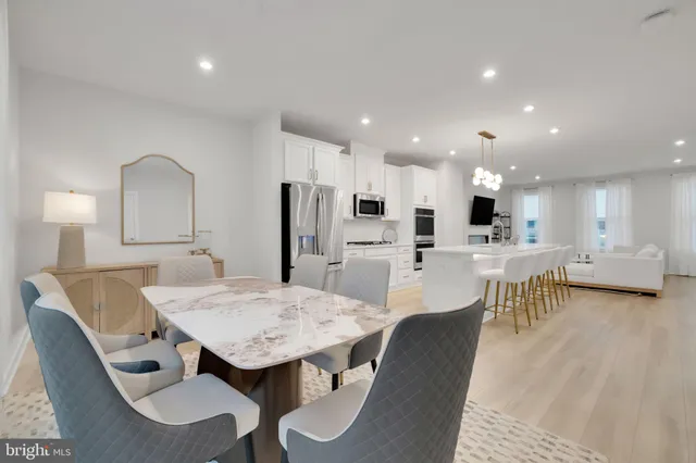 a view of kitchen with refrigerator dining table and chairs