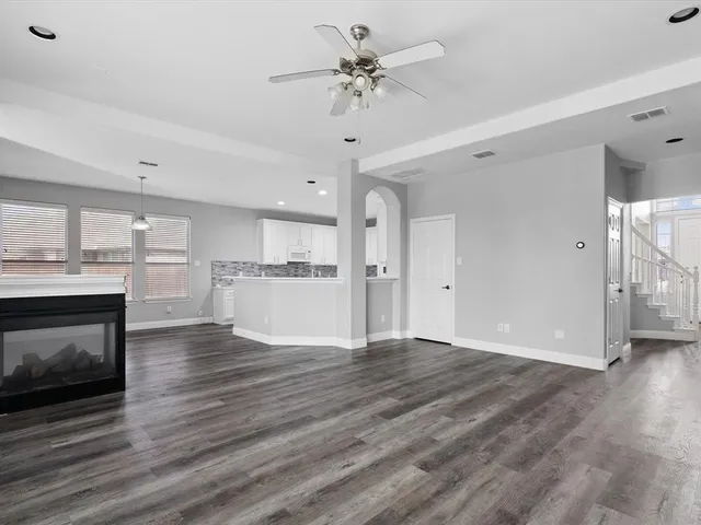 a view of a kitchen with a sink and a fireplace