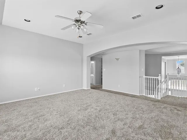 a view of an empty room with a fan
