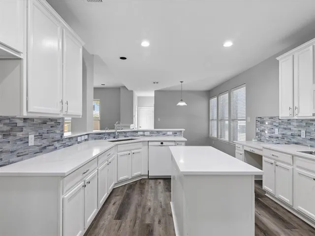 a kitchen with a sink and cabinets