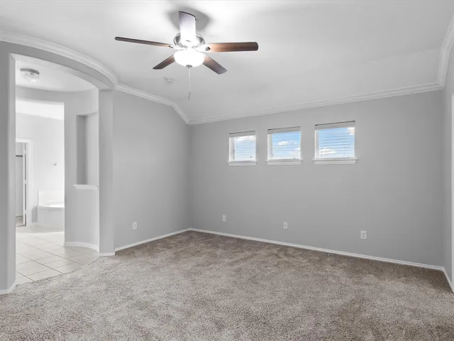 a view of an empty room with a ceiling fan